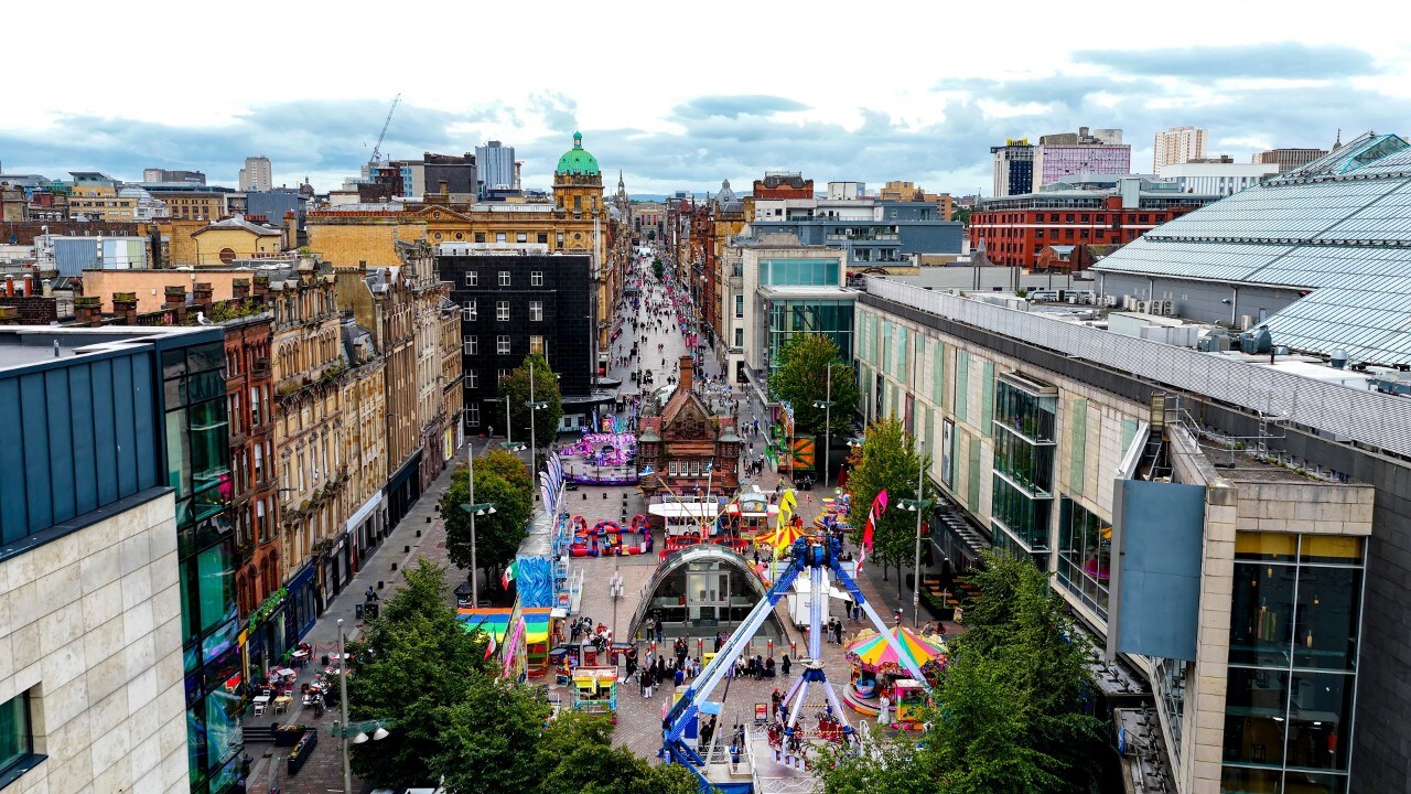 Buchanan Street and St. Enoch Square in Glasgow filled with colorful attractions, street activities, and pedestrians