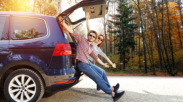 Couple sitting on the back of a people carrier