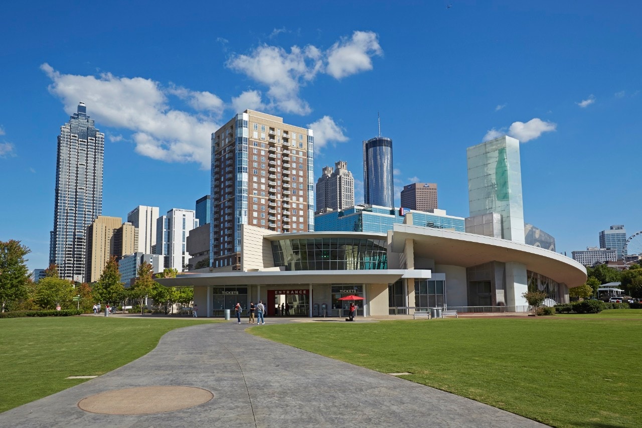 Cityscape of the skyscrapers of Downtown Atlanta from the 'Centennial Olympic Park' with the 'World of Coca Cola' attraction in foreground.