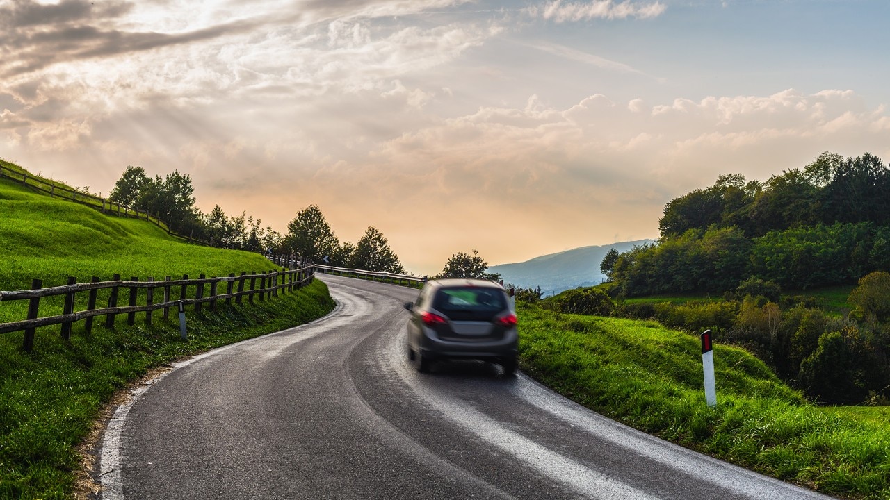 car through a country road.